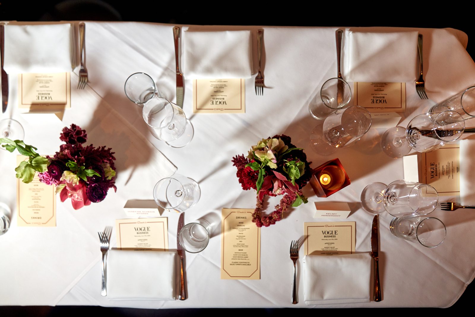 NYC brand press dinner with burgundy and green floral runner down a private dining room table